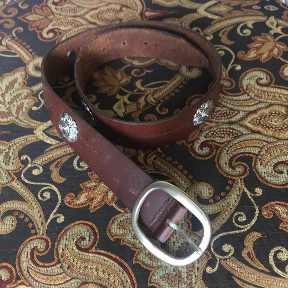 Women’s brown leather belt with silver buckle and silver studs. Size medium.